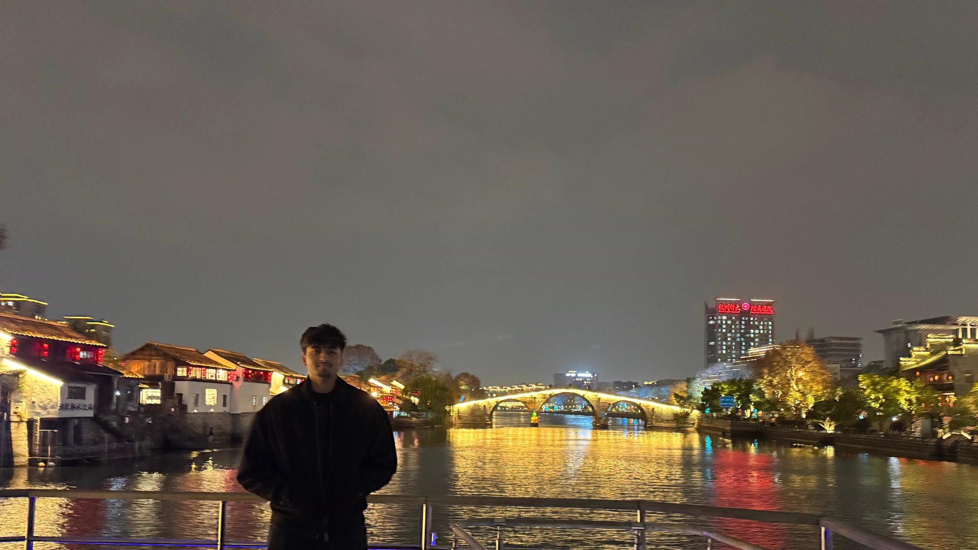 Chinmay on a canal boat at night